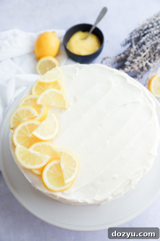 Lavender Lemon Curd Cake on cake stand with lemon slices on top