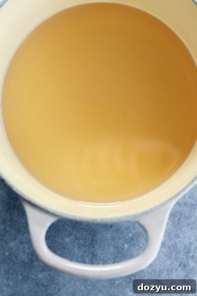 Vanilla simple syrup being made in a saucepan on the stovetop