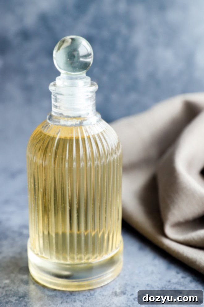 Close-up of a stylish dispenser bottle filled with homemade vanilla simple syrup