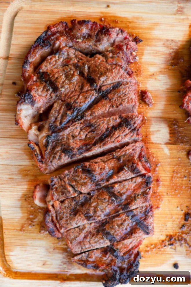 Sliced steak that has sat in a 3-ingredient steak marinade on cutting board