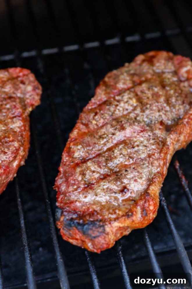Grilling steaks on the grill