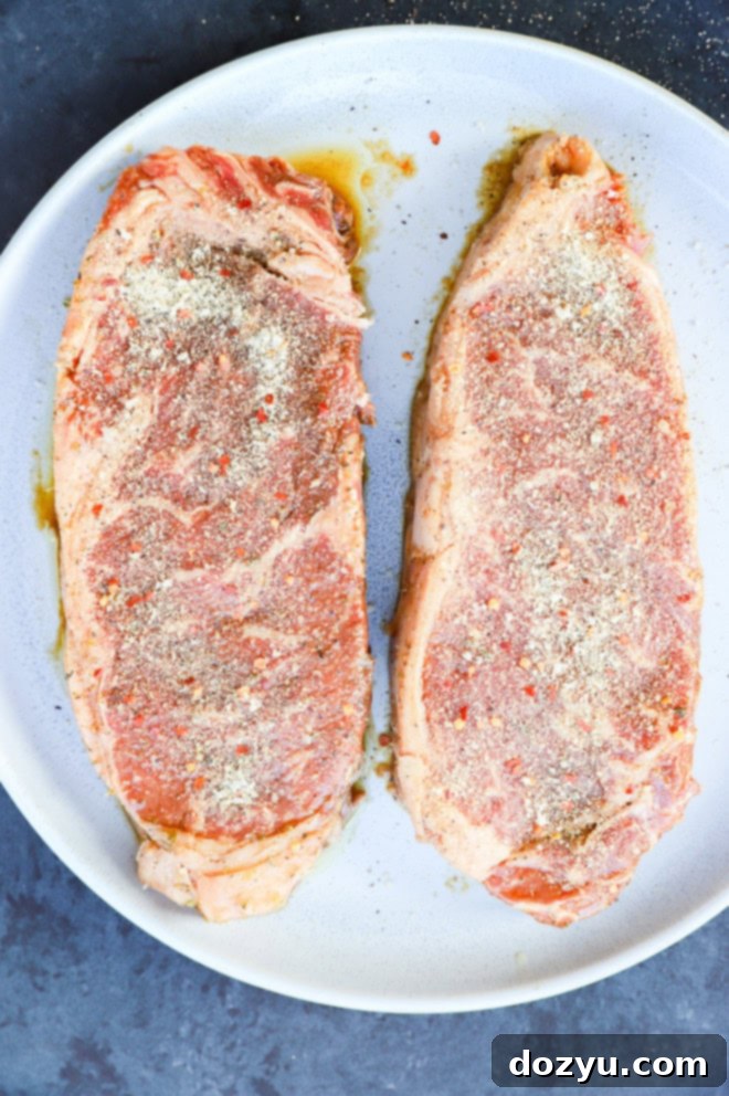 steaks on a plate seasoned with steak rub