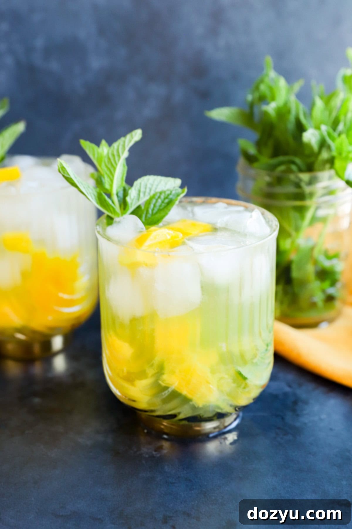 mango mojito in gatsby glasses with mint sprig garnish