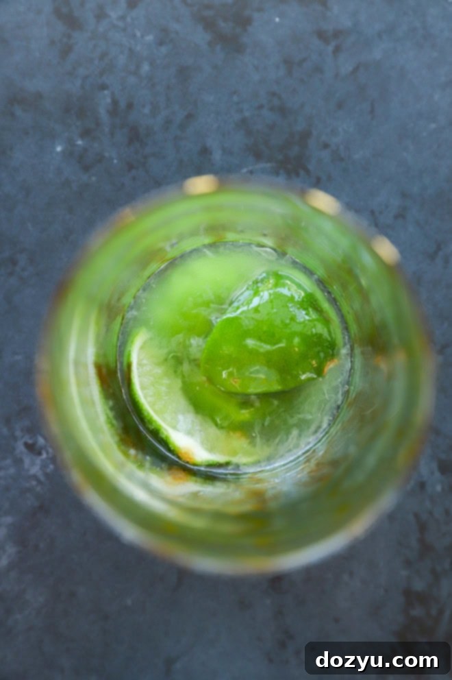 Bacardi Mojito: Your Perfect Refreshment 5 Muddled lime wedges and simple syrup in a glass