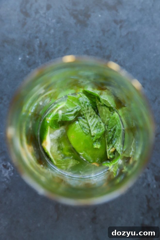 Bacardi Mojito: Your Perfect Refreshment 6 Muddled lime halves, mint leaves, and simple syrup in a glass