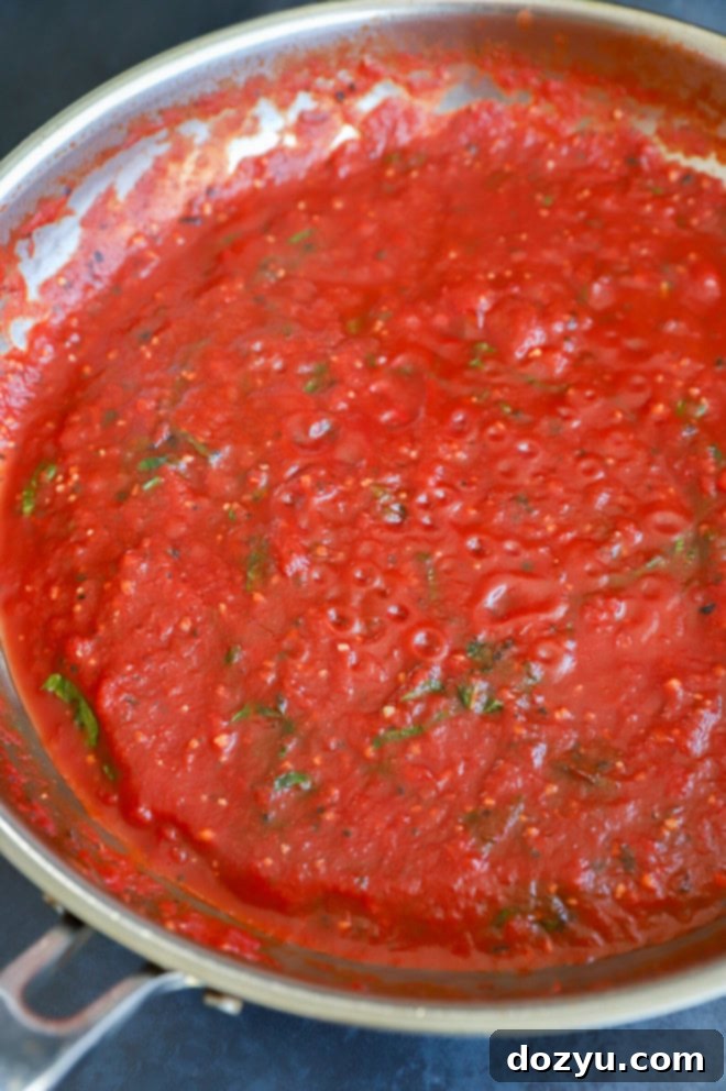 pomodoro sauce in a skillet with fresh basil