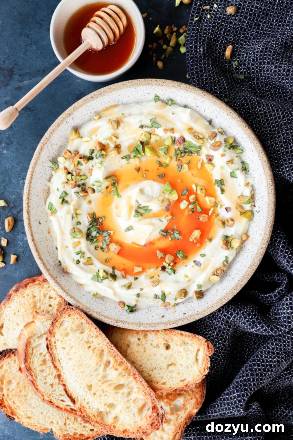 Cheesy dip with honey and toasted slices of bread, highlighting a beautiful whipped ricotta presentation.