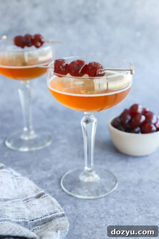 San Francisco cocktail in coupe glasses with brandied cherries