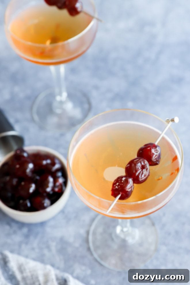 Classic drink in coupe glasses with cherries