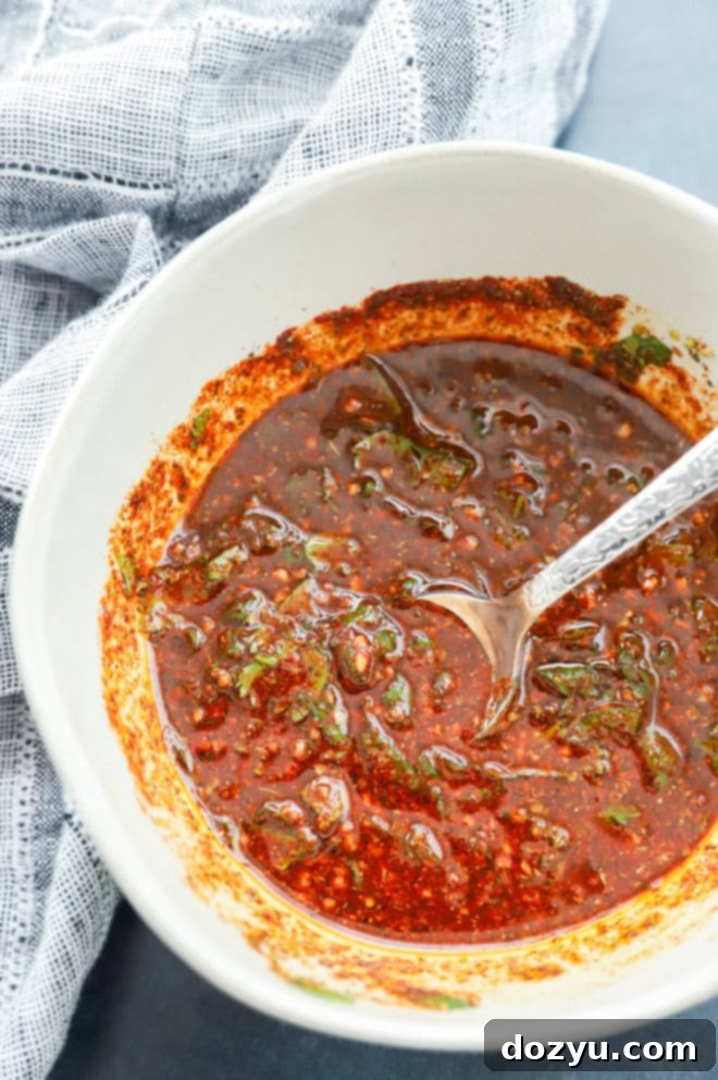 Bowl of mexican chicken marinade with linen underneath