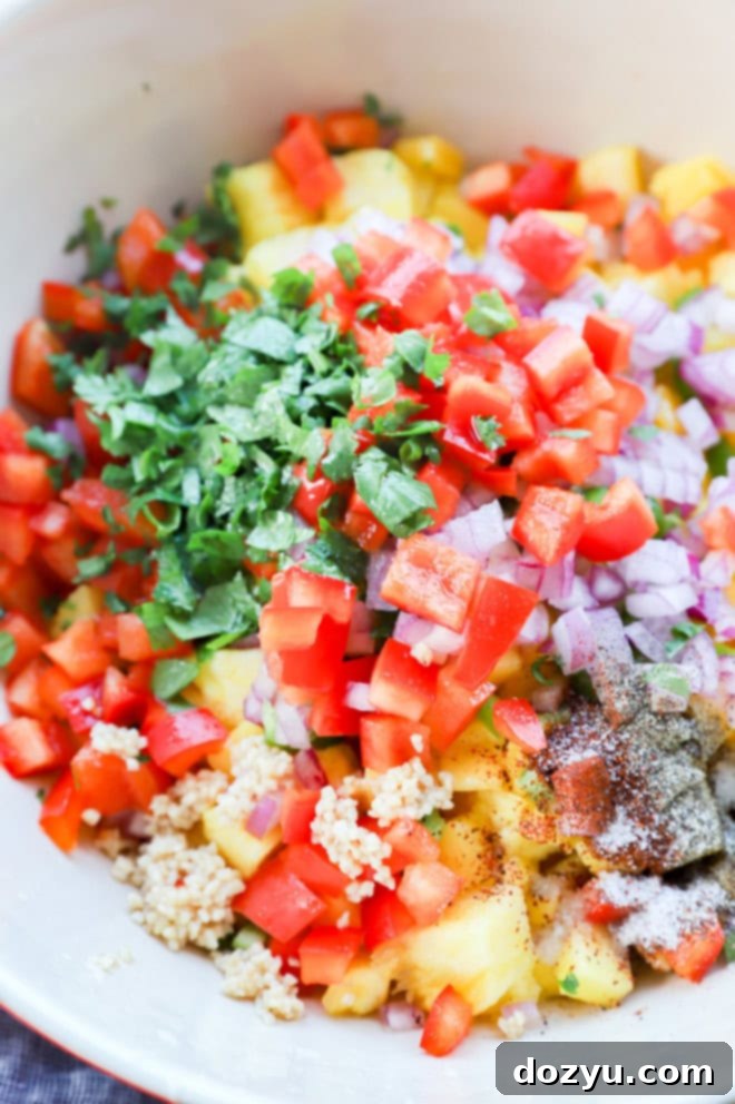 making pineapple mango salsa in a large bowl with all the ingredients before stirring