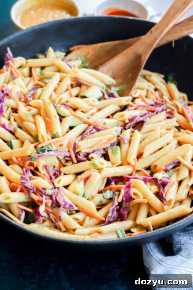 wooden utensils with noodles in a bowl