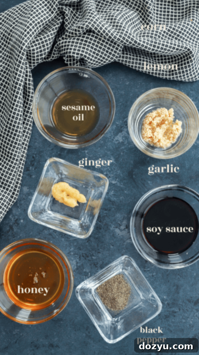 Honey soy marinade ingredients laid out in bowls with text labels, including soy sauce, honey, sesame oil, garlic, ginger, and black pepper.
