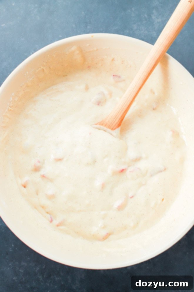 Strawberry Dream Waffles 4 strawberry waffles batter in bowl with wooden spoon