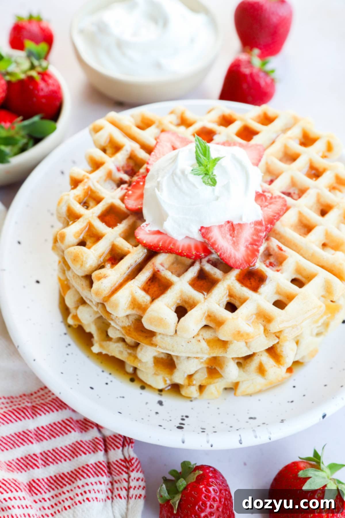 Strawberry Dream Waffles 9 Stack of strawberry waffles with syrup on top