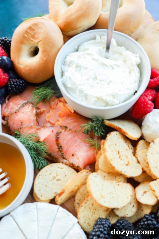 image of mini bagels, whipped cream cheese, and smoked salmon on a platter, ready for a breakfast board