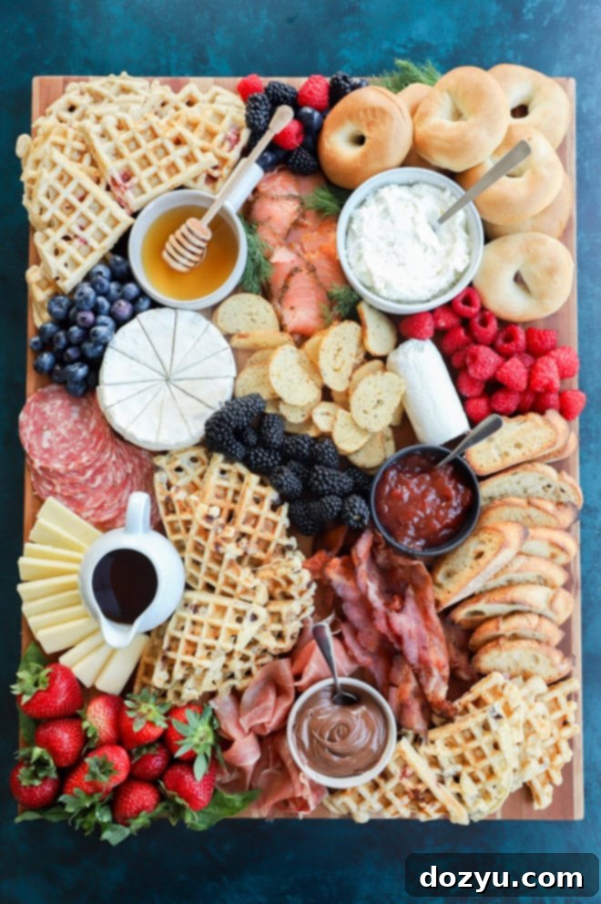 easy breakfast charcuterie board with fresh fruit, meats, cheeses, waffles, and more, beautifully arranged