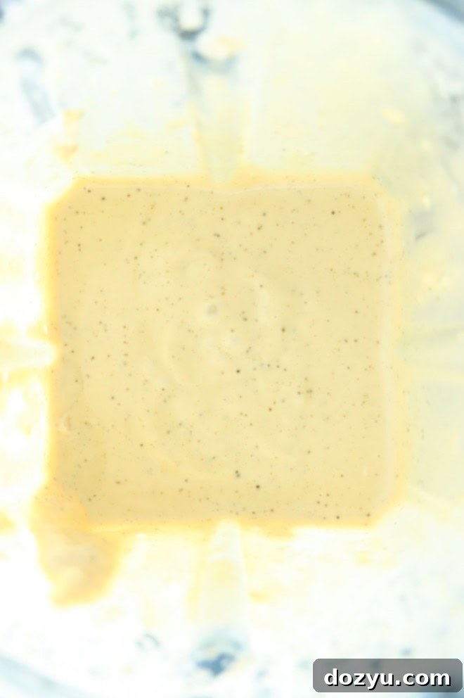 making homemade caesar dressing recipe in a blender, showing the smooth consistency