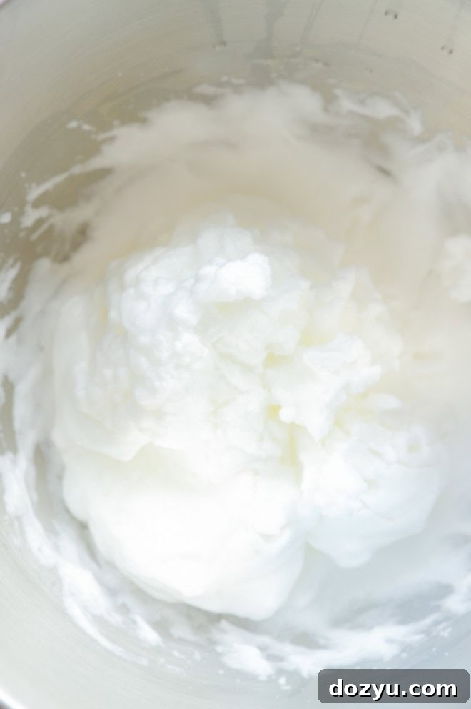 egg whites beaten to stiff peaks in stand mixer bowl