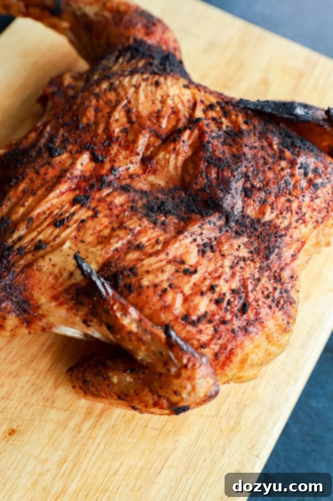 grilled full chicken on cutting board image
