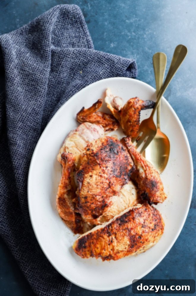 pieces of poultry on serving platter with linen and serving utensils