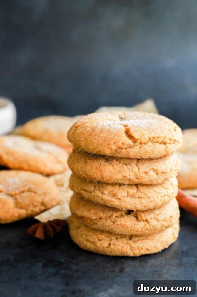A delightful stack of pumpkin pie spice cookies, garnished with cinnamon sticks, perfect for fall.