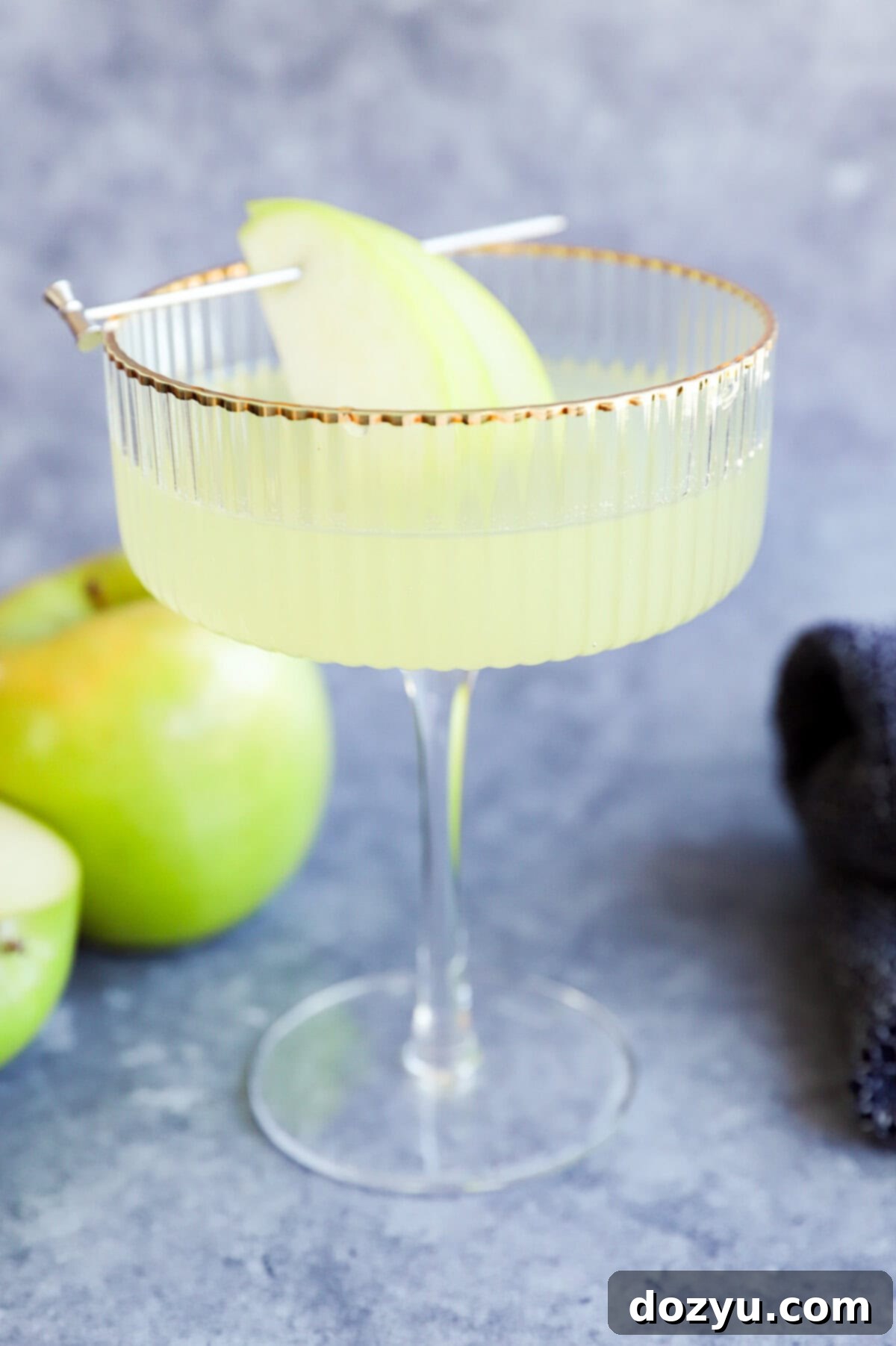 fresh apple martini in couple glass with fresh apples in the bckground
