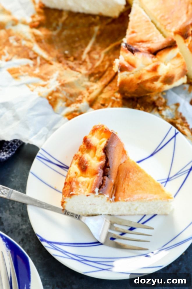 a slice of burnt basque dessert on plate with a fork