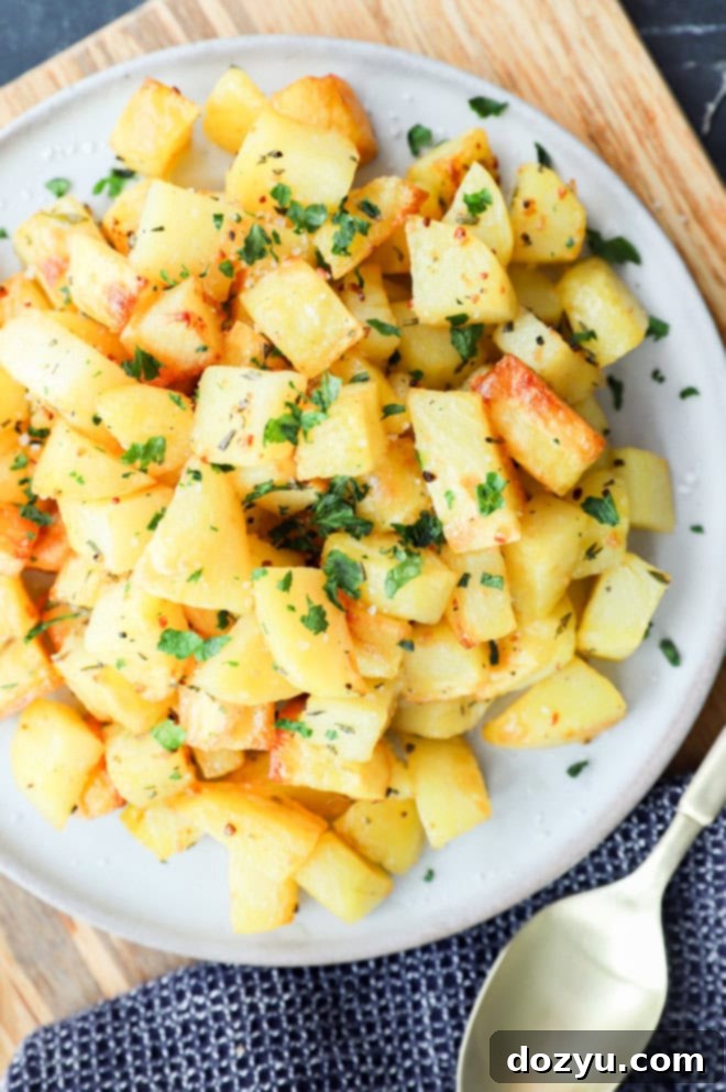 parmentier potatoes on a plate with gold spoon, wood, and black linen