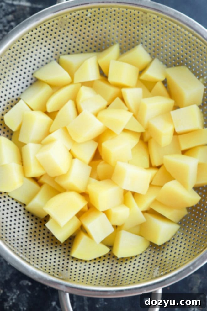 drained parboiled potatoes in a colander
