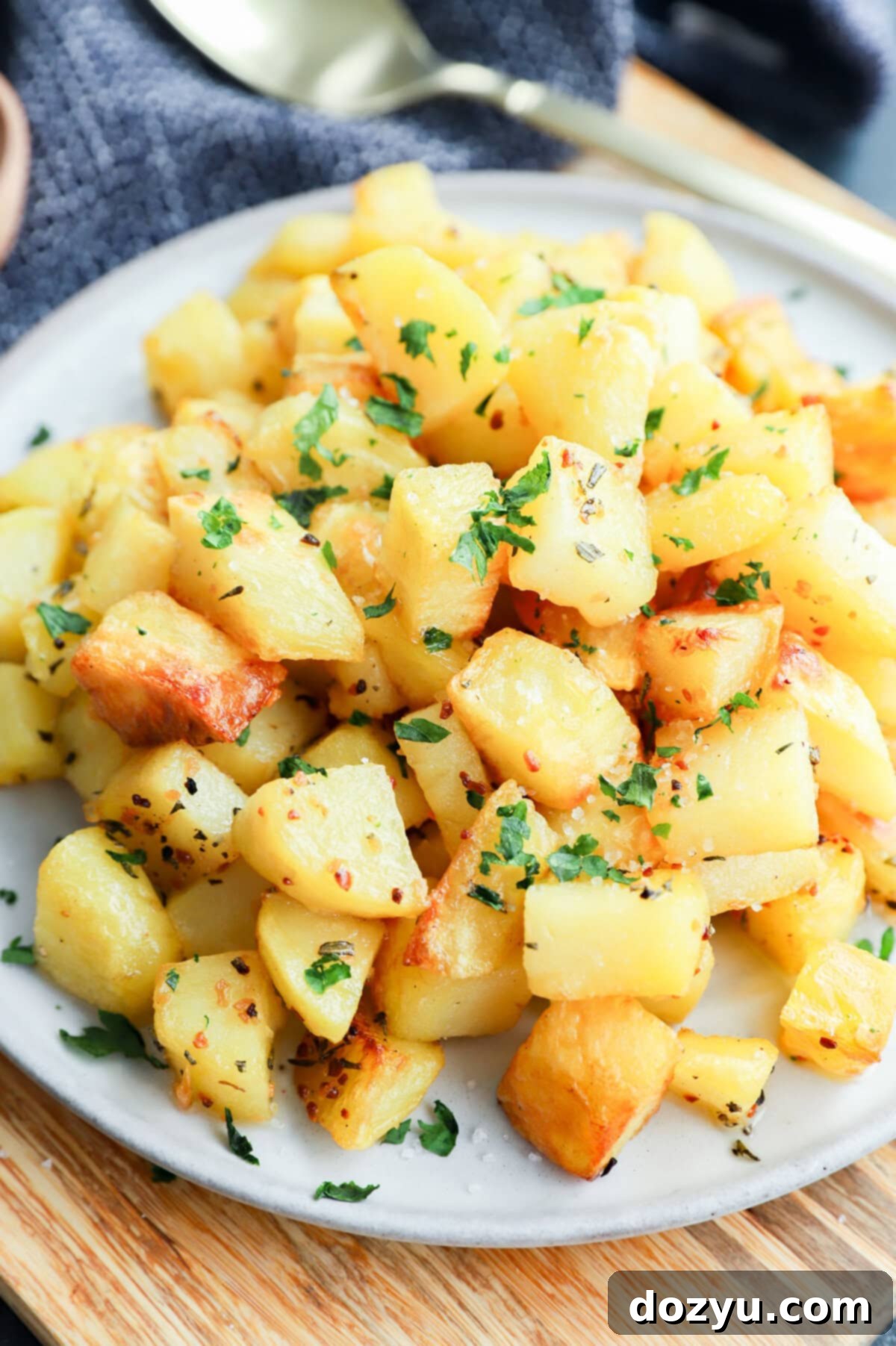 platter of golden potato cubes on platter with gold spoon