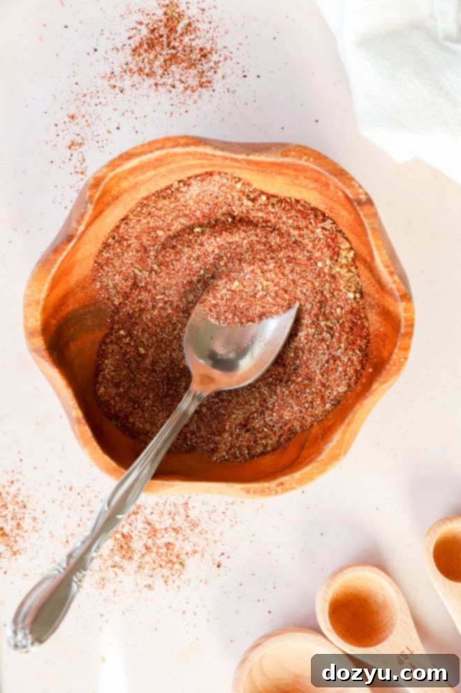 Make Your Own Chili Seasoning Mix 5 A close-up image of a perfectly mixed homemade spice blend in a bowl, with a spoon resting beside it, ready to be used in various culinary creations.