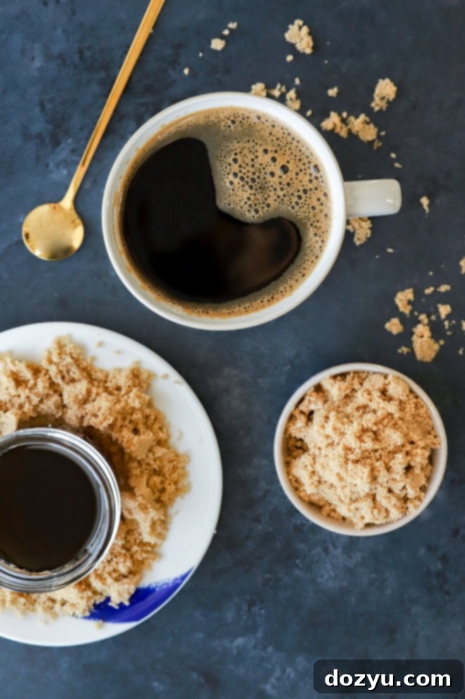 coffee mug with dark coffee and sweetener