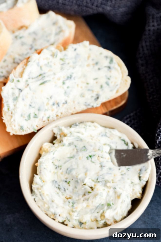 garlic herb butter in bowl and spread on bread on cutting board