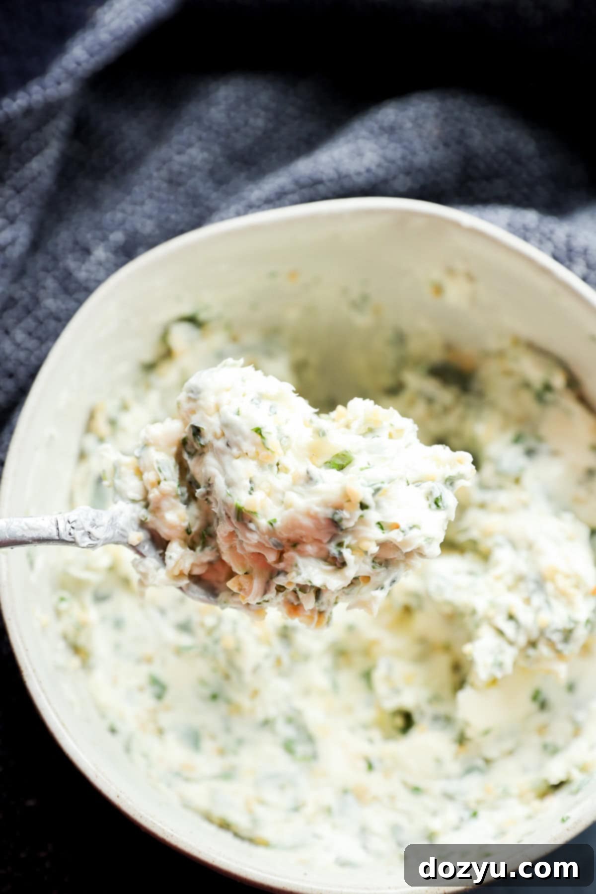 spoonful of compound butter with fresh parsley thyme and basil