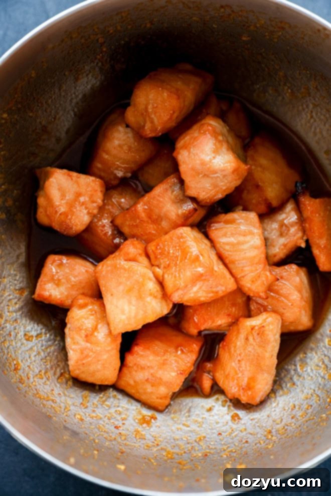cooked fish pieces in bowl with glaze