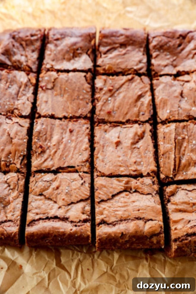 sliced coffee brownies with flaky sea salt on parchment paper