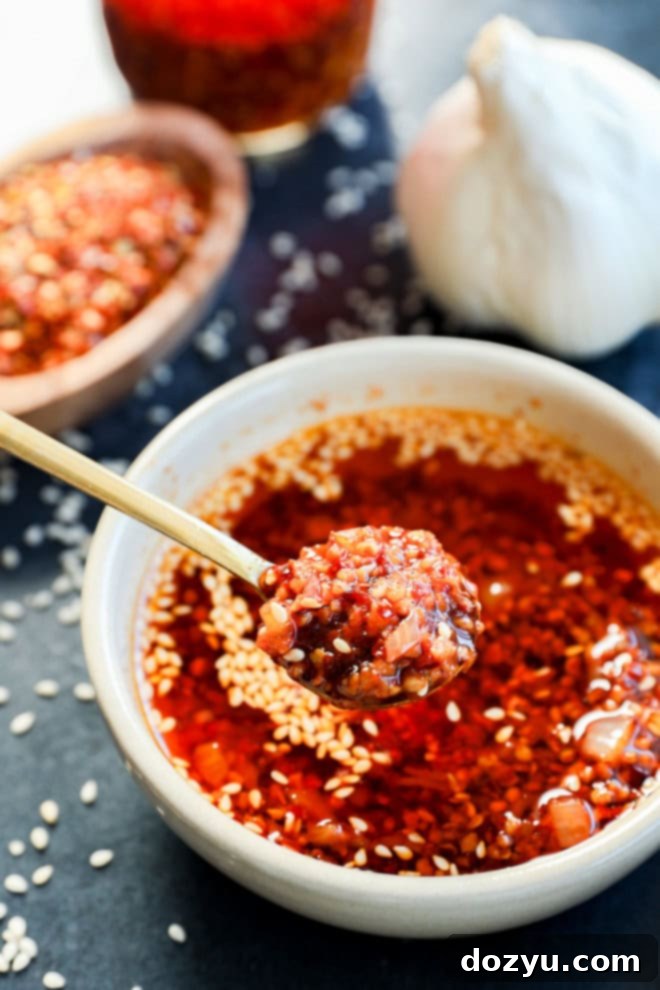 spooning out chili garlic oil recipe from a bowl