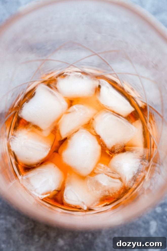 pink gin cocktail stirred together in mixing glass