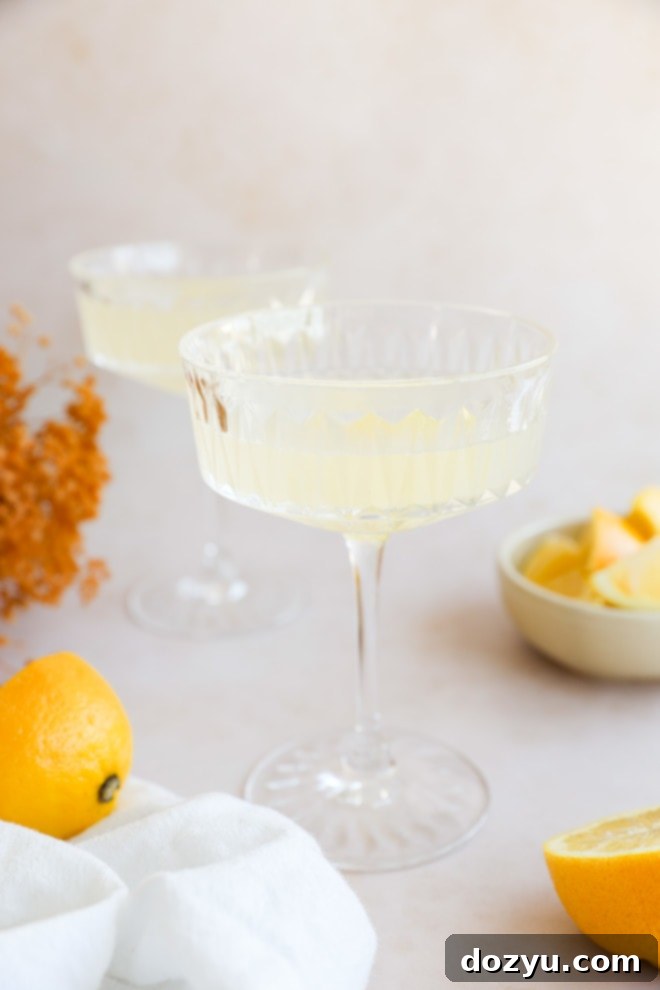 Sip on Perfection: The Bee's Knees Cocktail 2 lemony cocktails in coupe glasses with flowers