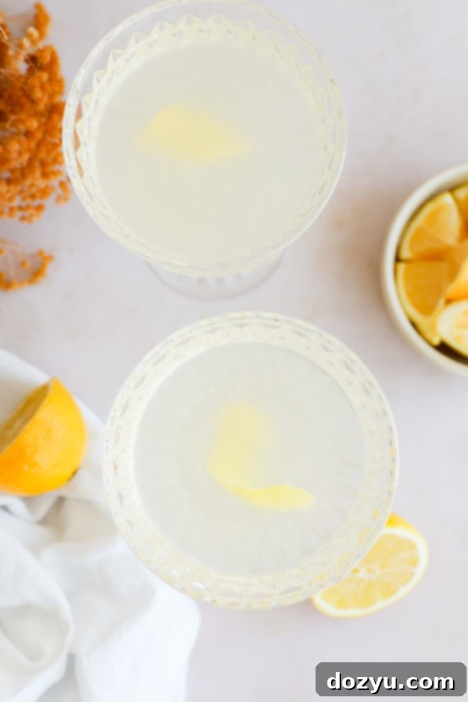 Sip on Perfection: The Bee's Knees Cocktail 7 bees knees cocktails in coupe glasses with fresh lemons and flowers