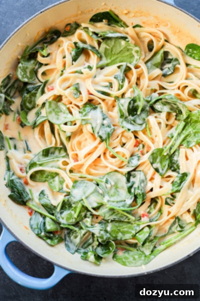 Velvety Lemon Salmon Pasta 5 creamy lemon sauce with fettuccine and spinach in a skillet