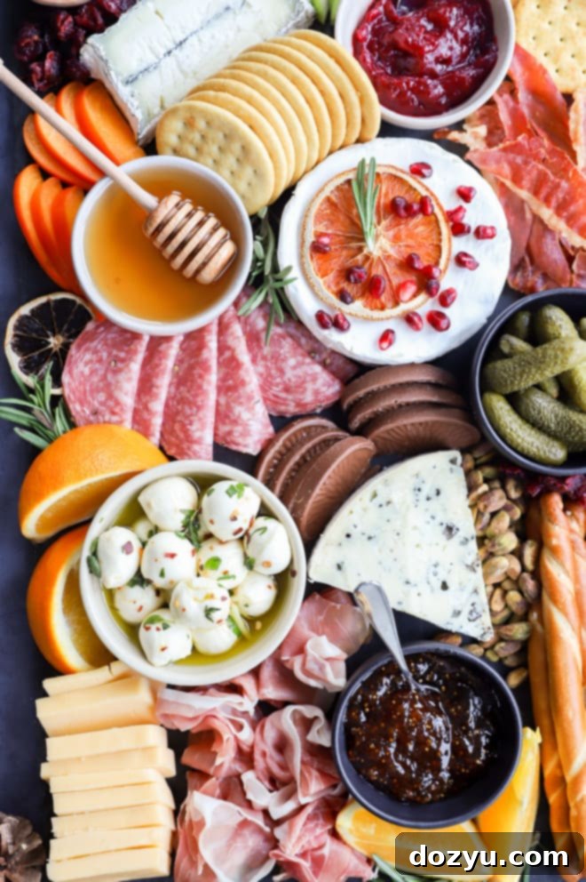 image of marinated mozzarella balls in bowl with other appetizers on a festive Christmas cheese board