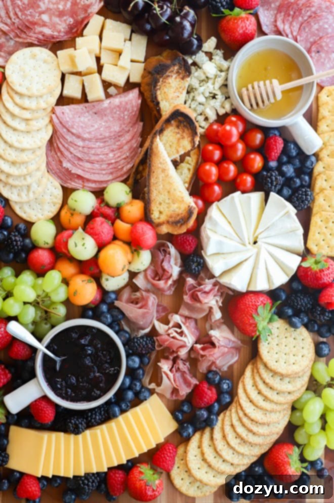 Image of summer charcuterie board with vibrant fruits, cheeses, and dips