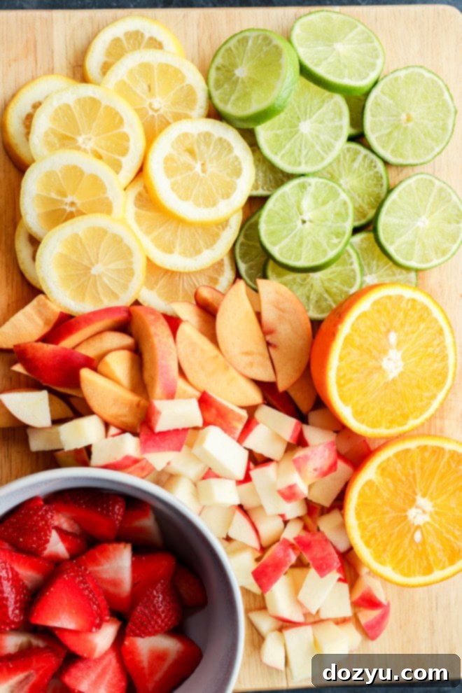 citrus slices and fresh fruit chopped on a wooden cutting board