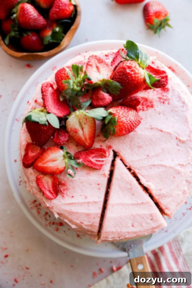 cutting a slice of fresh berry pink dessert with fresh fruit on top