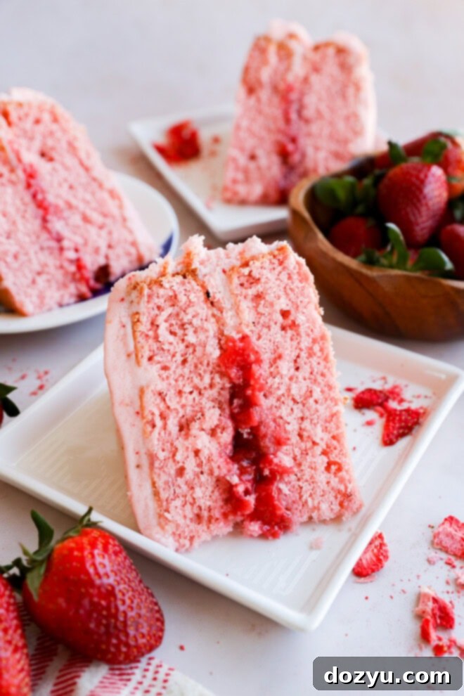 plates of slices of pink dessert with fresh fruit in the center and pink frosting