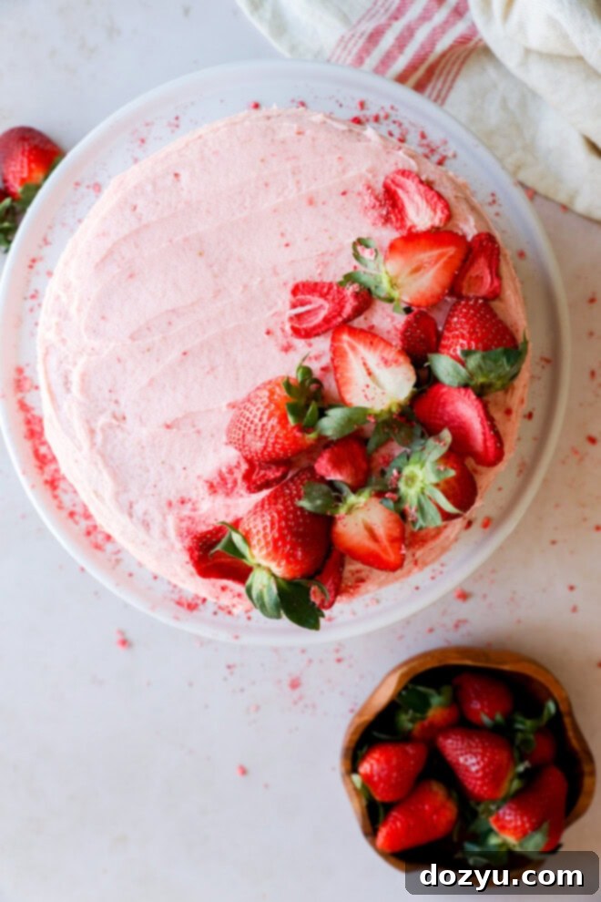 strawberry cake with strawberry filling on white cake plate