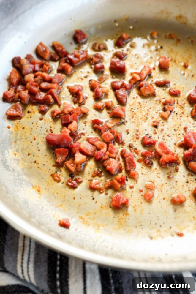 Pancetta cooking and crisping in a skillet