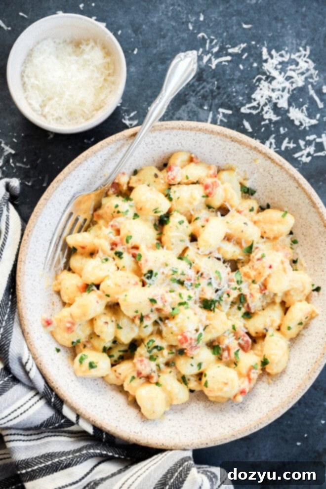 Bowl of gnocchi carbonara with cheese and fresh herbs and a fork